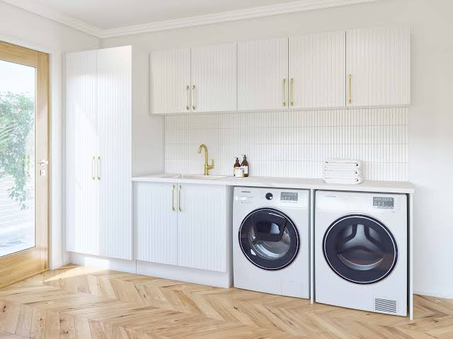 Clean, well-organised laundry room with washing machines